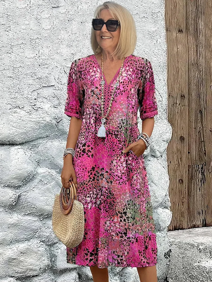 Pink floral print midi dress with V-neck and pocket detail, casual style
