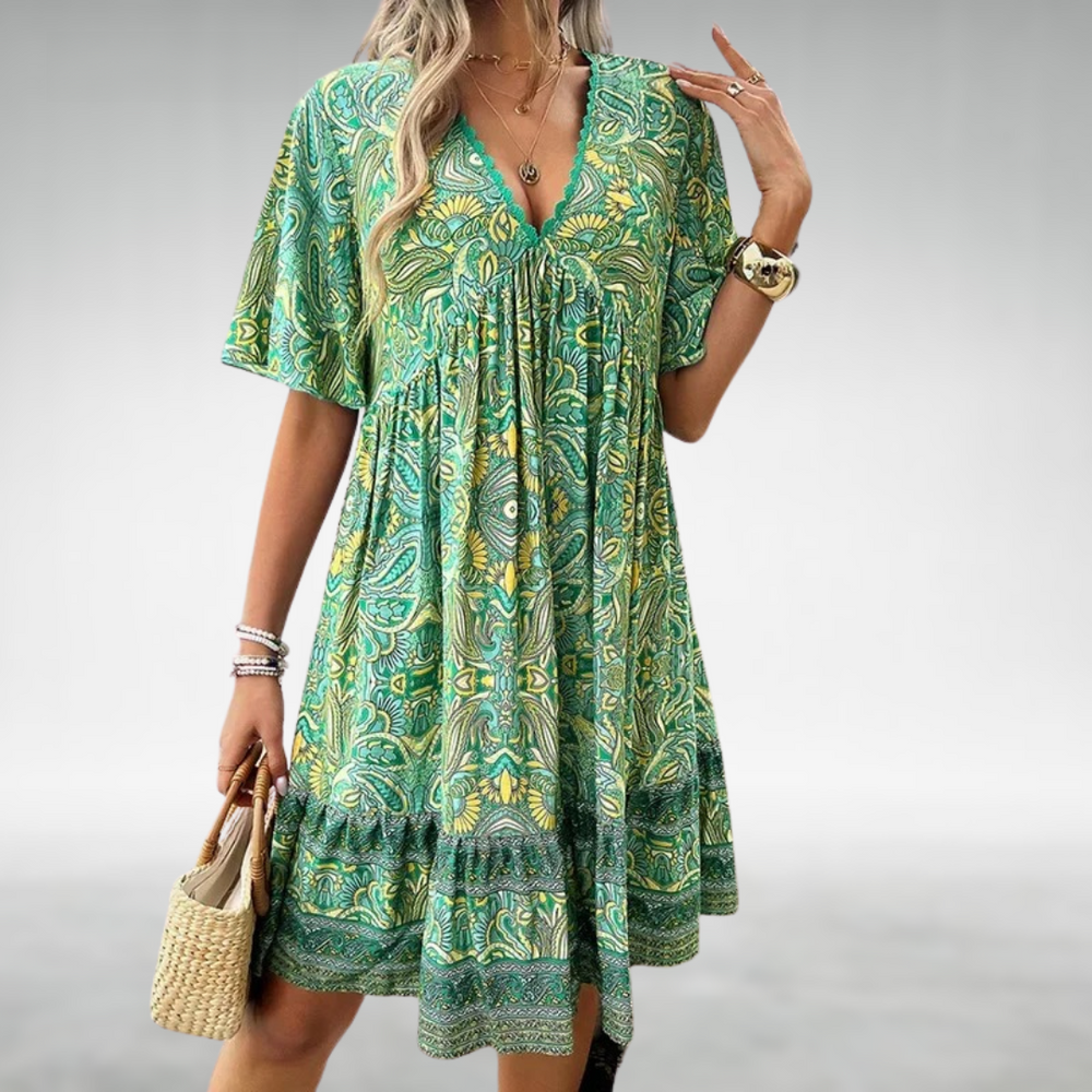 Green paisley print babydoll dress with flutter sleeves and lace neckline