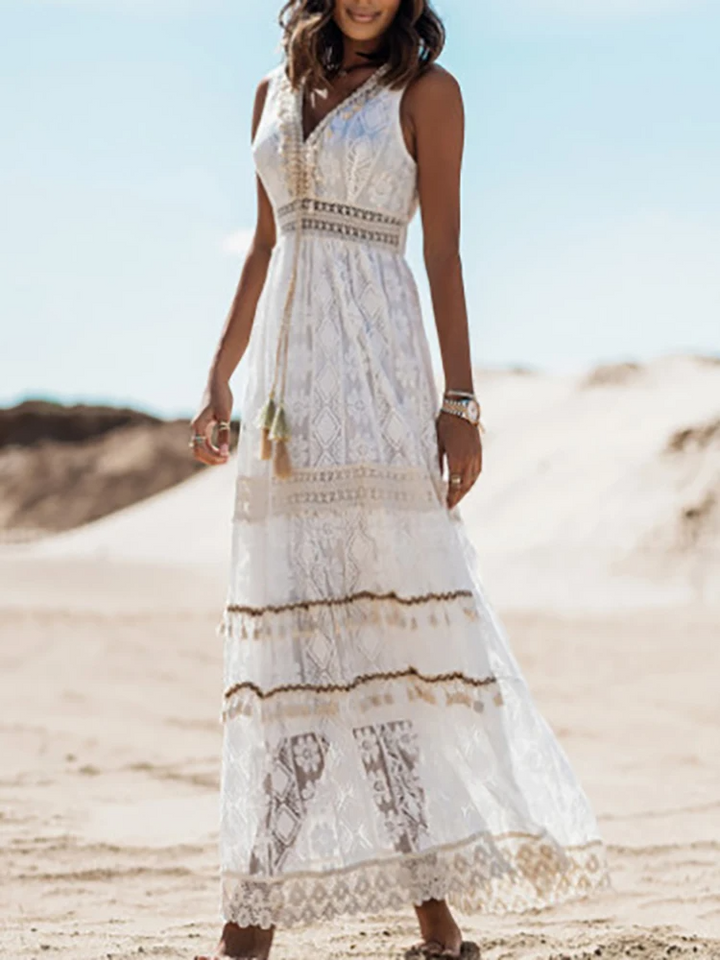 White boho maxi dress with V-neckline, crochet waistband, and tiered lace hem