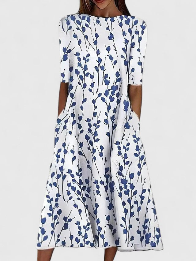 White midi dress with blue botanical leaf print and short sleeves