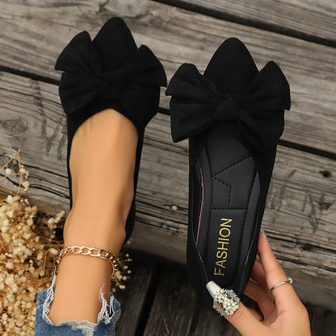 Black suede ballet flats with layered bow accent, shown side by side