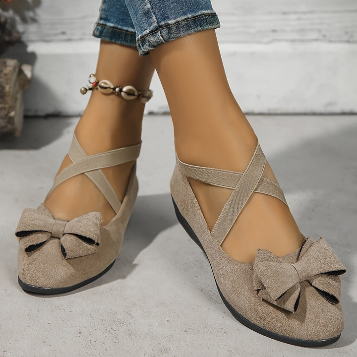 Taupe suede bow flats with crossover ankle strap styling