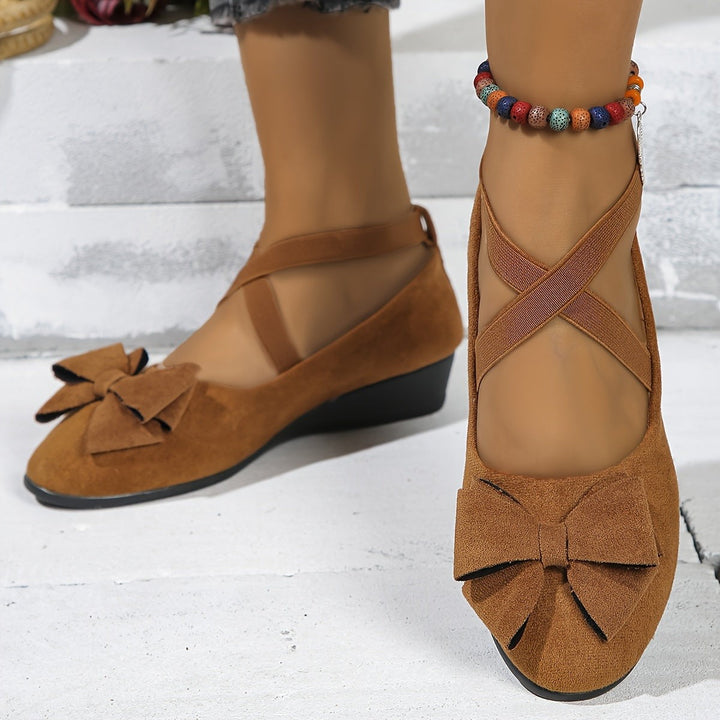 Camel suede wedge flats with bow accent and crossover ankle straps