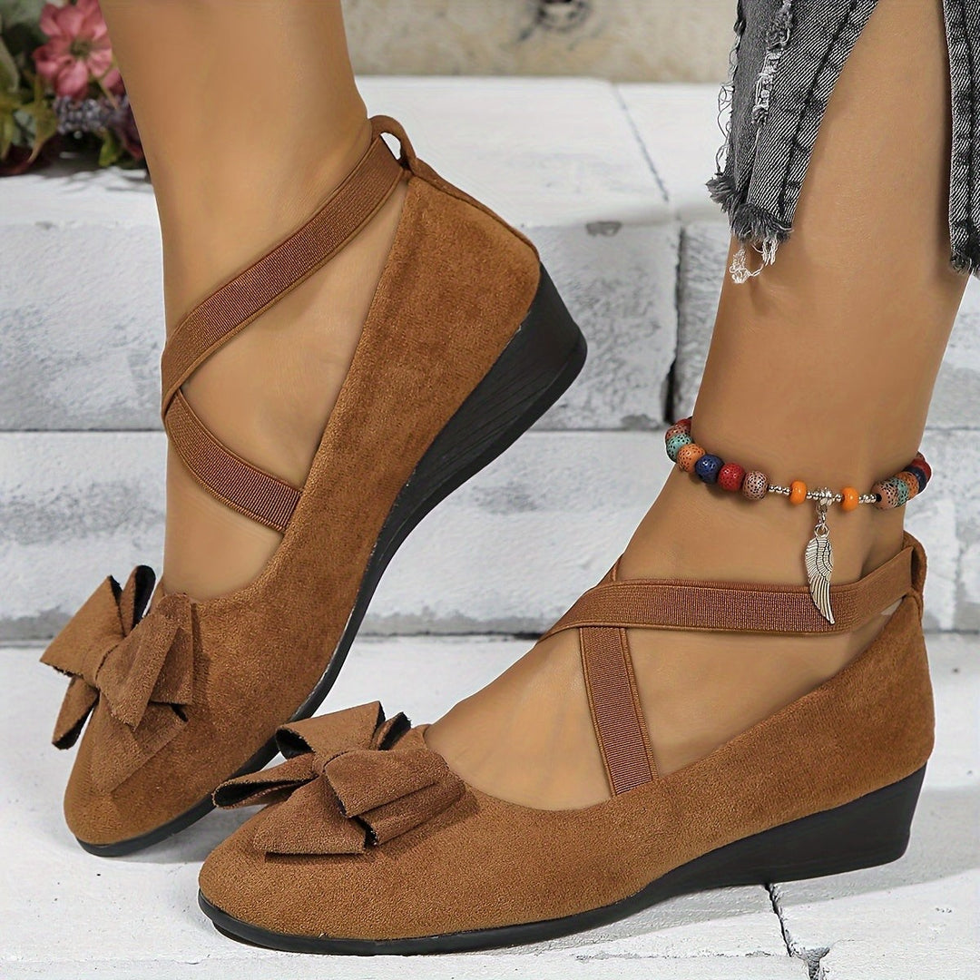 Brown suede flats with bow accent and crossover elastic straps