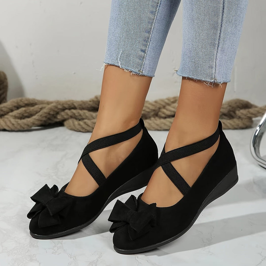 Black suede wedge flats with bow detail and crisscross straps