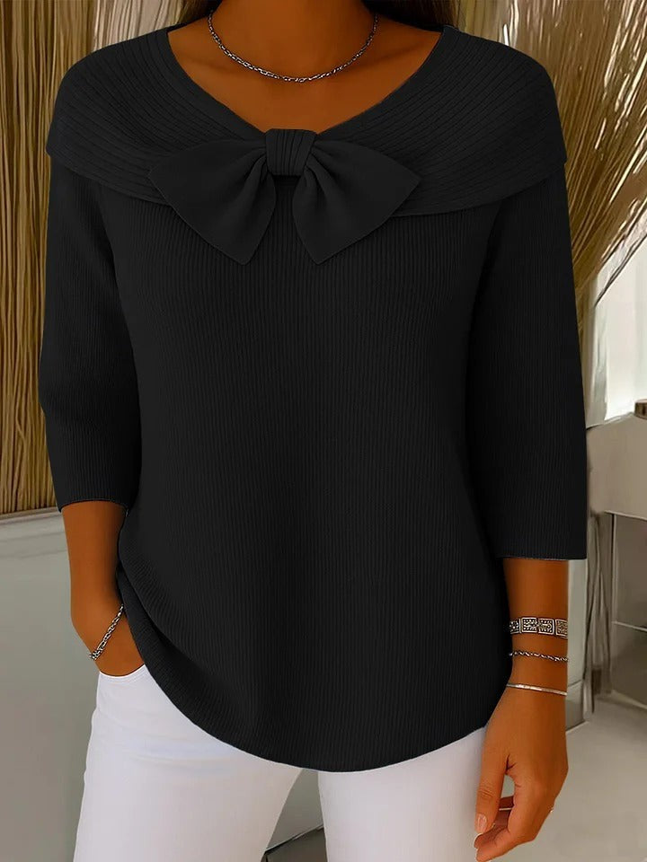 Black ribbed knit sweater with bow neckline and relaxed three-quarter sleeves