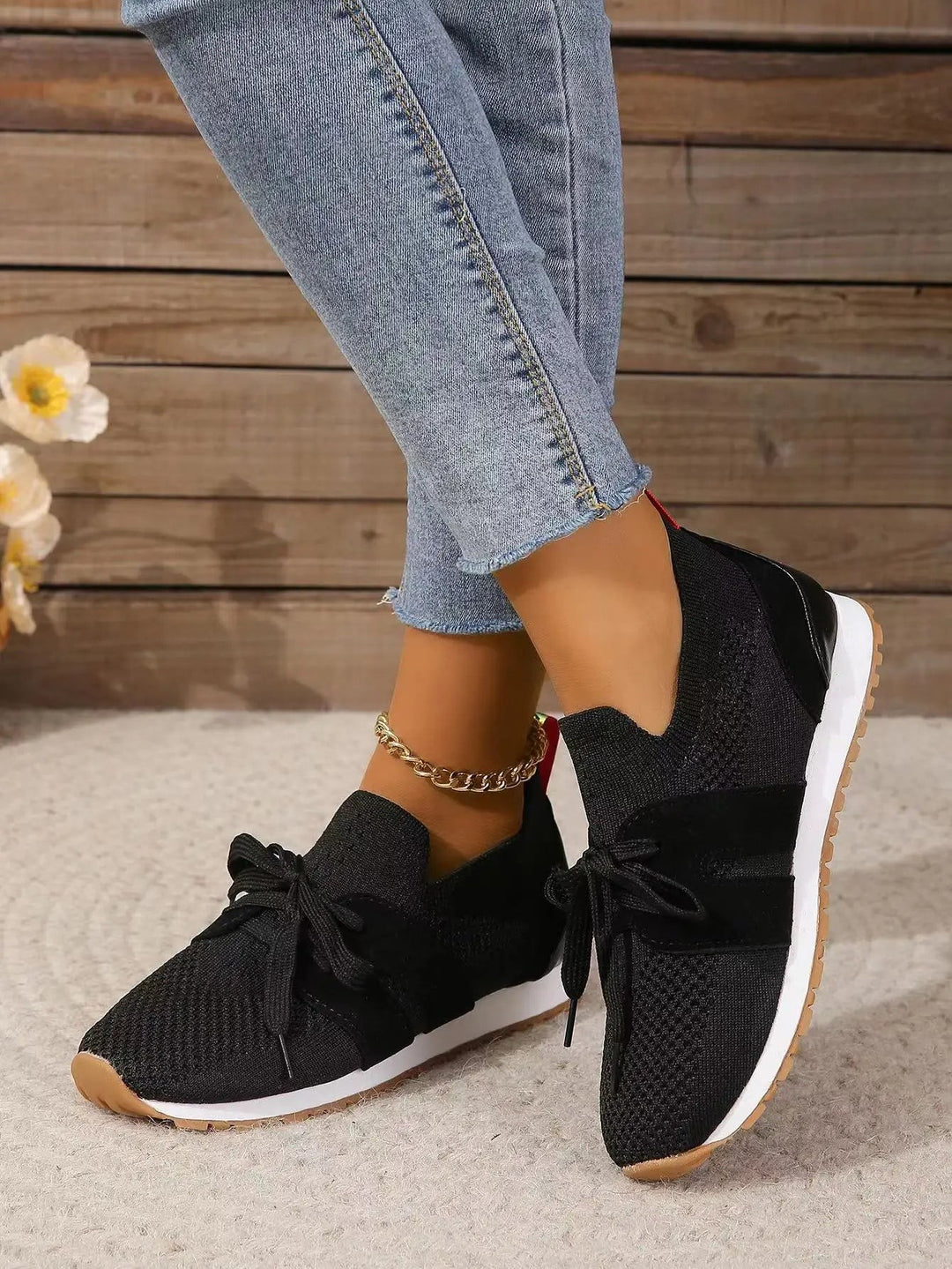 black knit slip-on sneakers with bow lace detail and gum sole