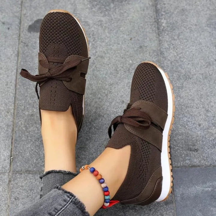 brown mesh slip-on sneakers viewed from above with tied bow