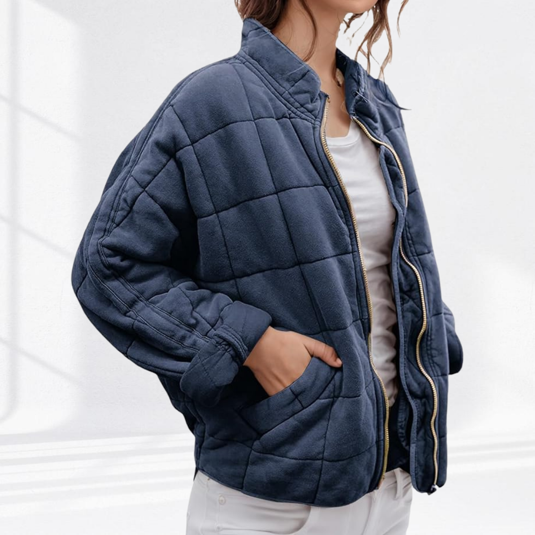 Navy quilted puffer jacket showing tailored box-quilt stitching detail
