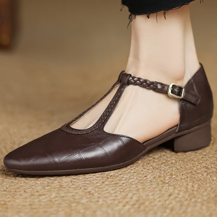brown leather T-strap flats worn on foot showing low block heel