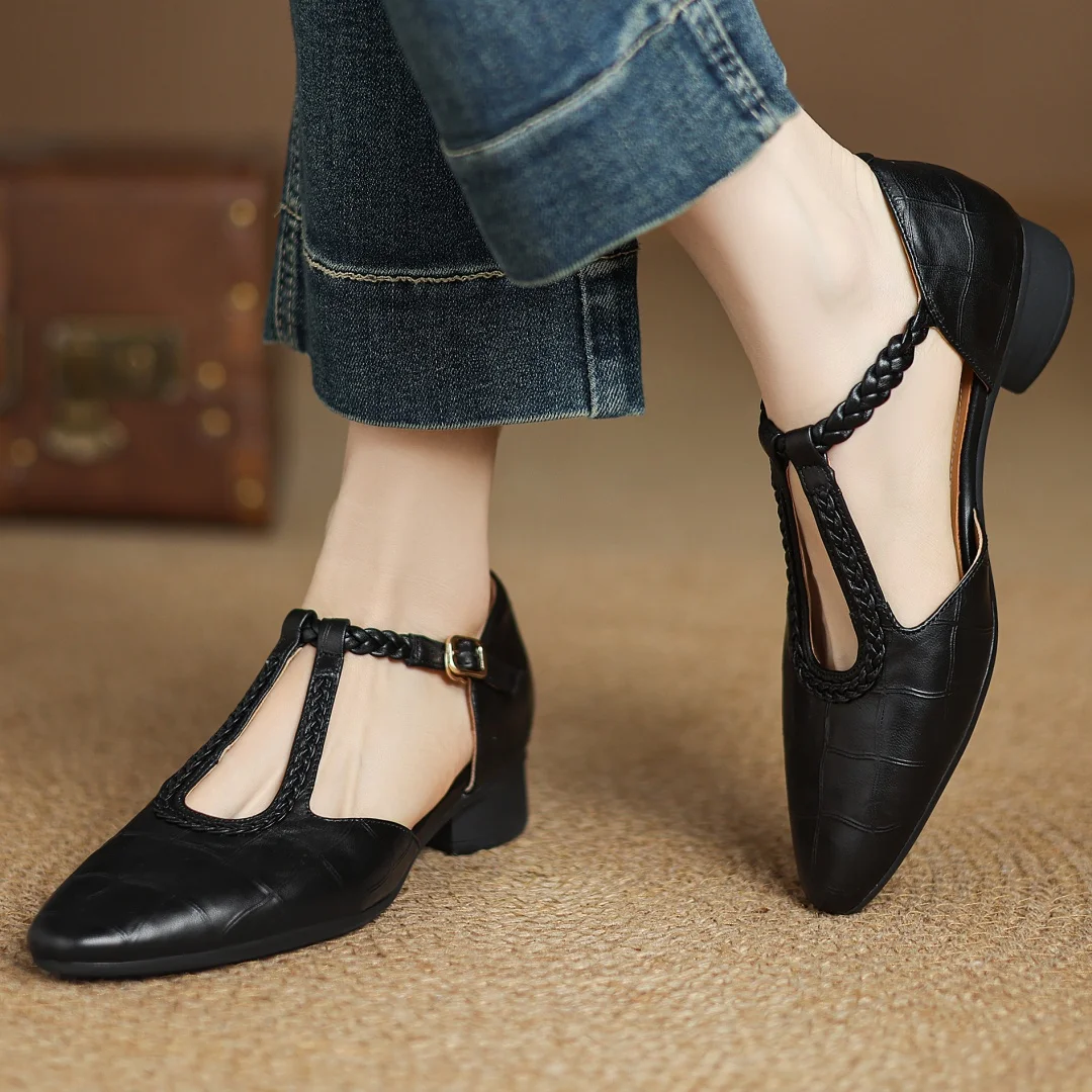 brown and black leather Mary Jane flats side by side showing braided straps
