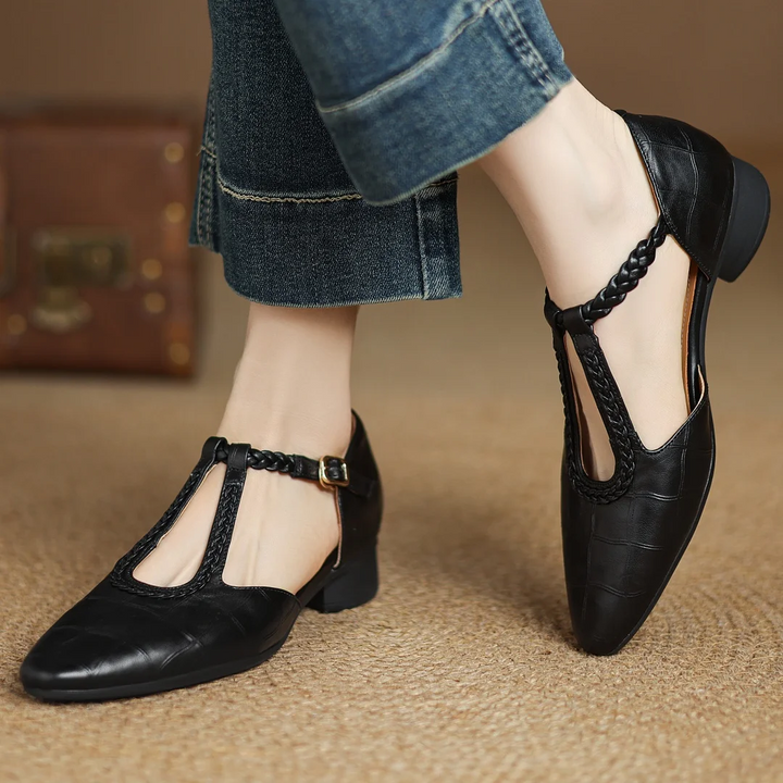 brown and black leather Mary Jane flats side by side showing braided straps