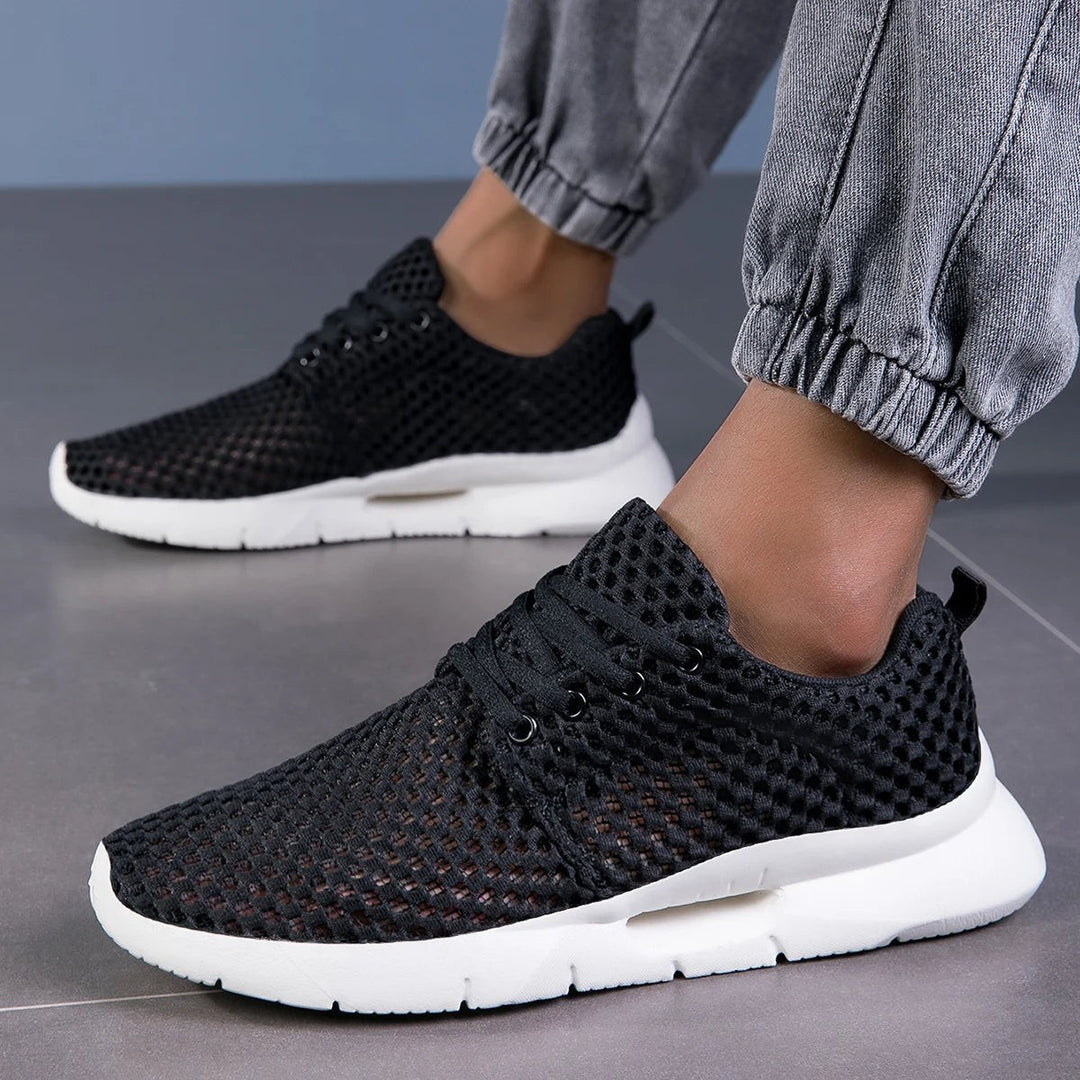Black breathable knit sneakers paired with gray jogger pants