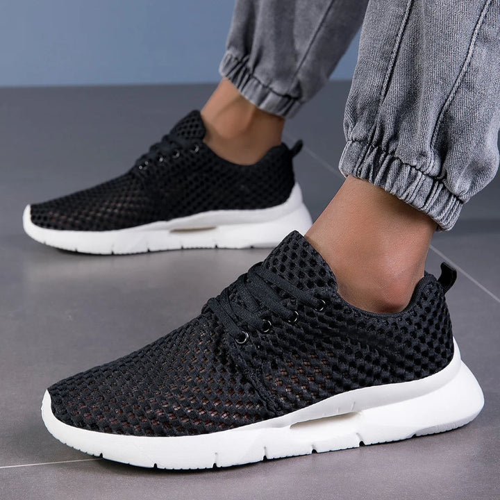 Black breathable knit sneakers paired with gray jogger pants