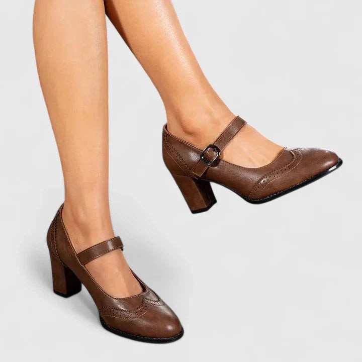 Brown leather Mary Jane pumps with buckle strap and block heel on model