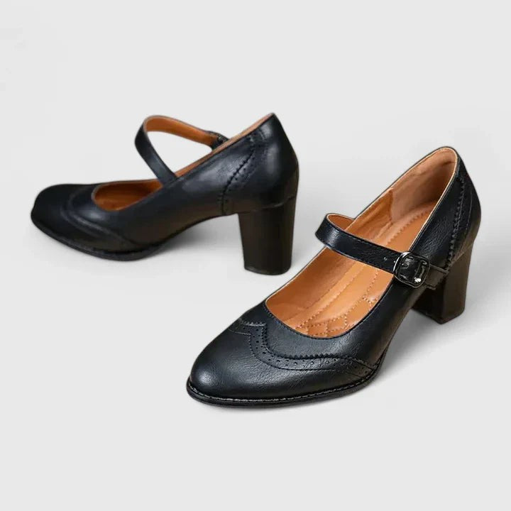 Black leather Mary Jane pumps with wingtip brogue detailing and block heel