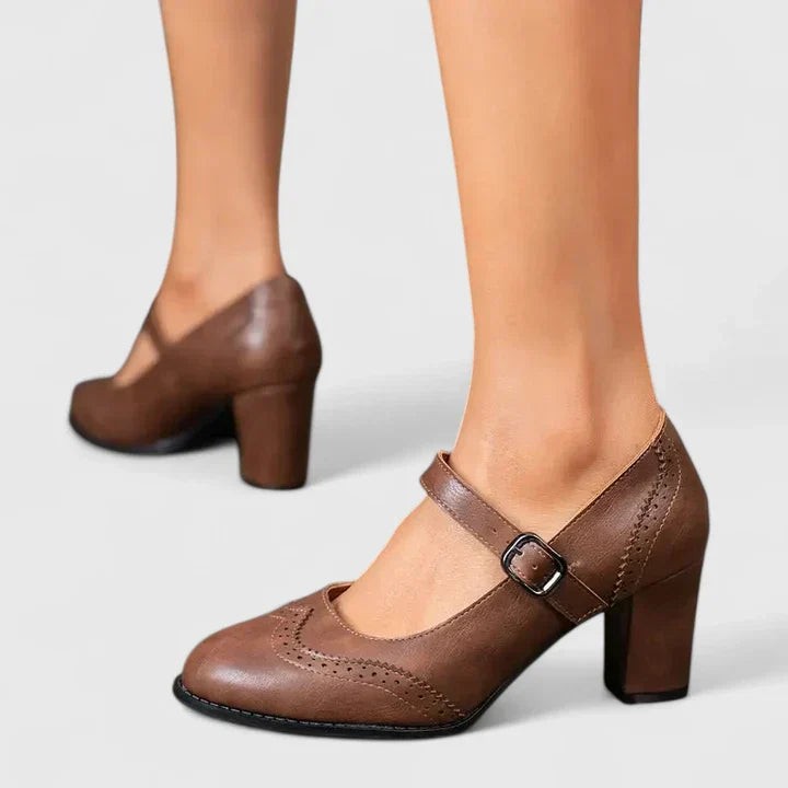 Brown leather Mary Jane shoes with brogue wingtip detail and block heel