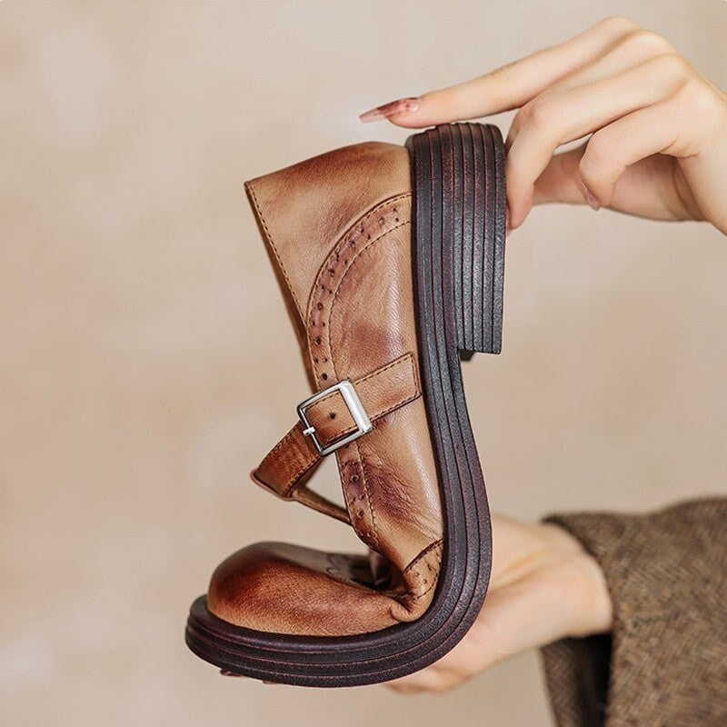 hand holding brown leather Mary Jane shoe showing block heel and stacked sole