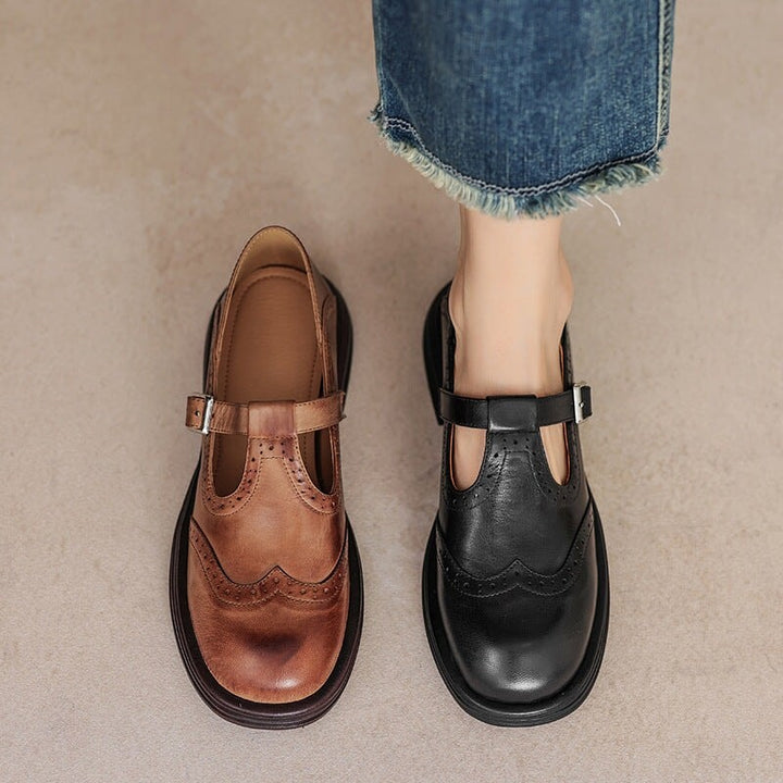 brown and black leather Mary Jane brogue shoes side by side with denim jeans