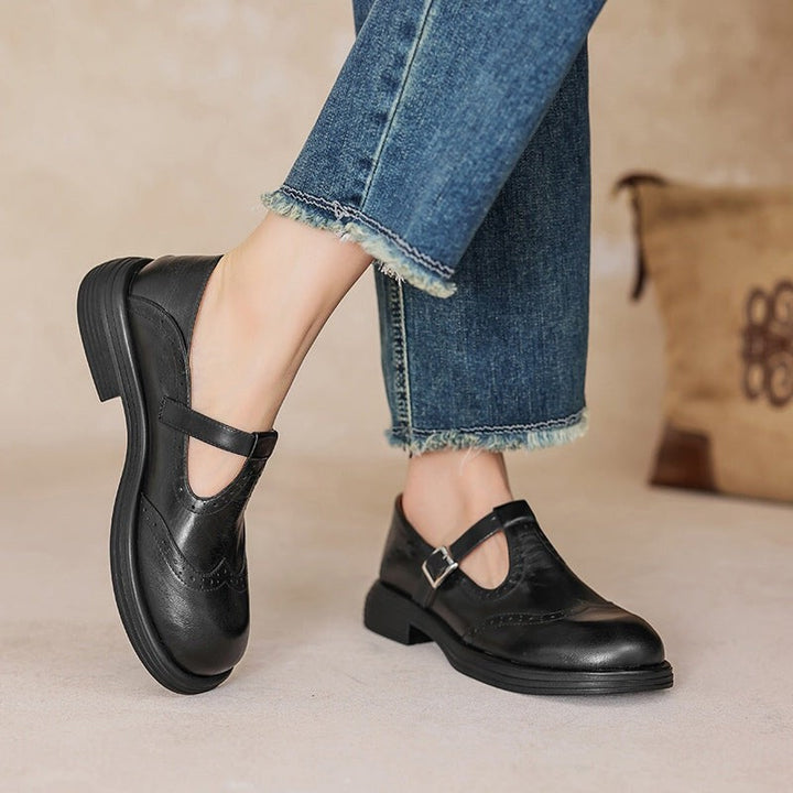 black leather T-strap Mary Jane shoes with brogue detailing worn with cropped jeans