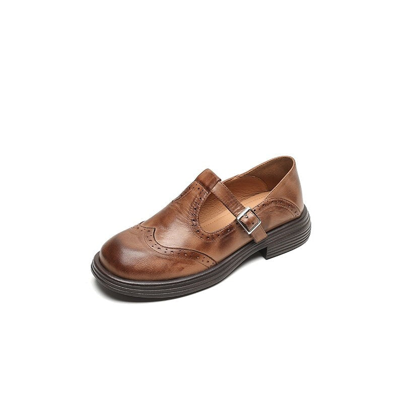 brown leather Mary Jane shoe with wingtip brogue detail and buckle strap, side view