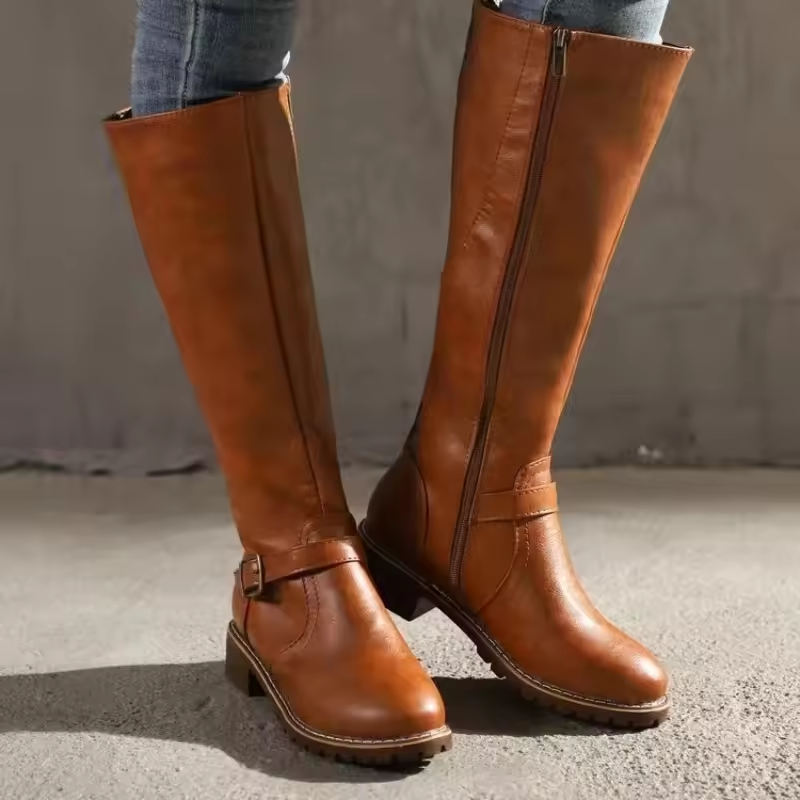 Tan knee-high leather boots with side zipper and buckle accent