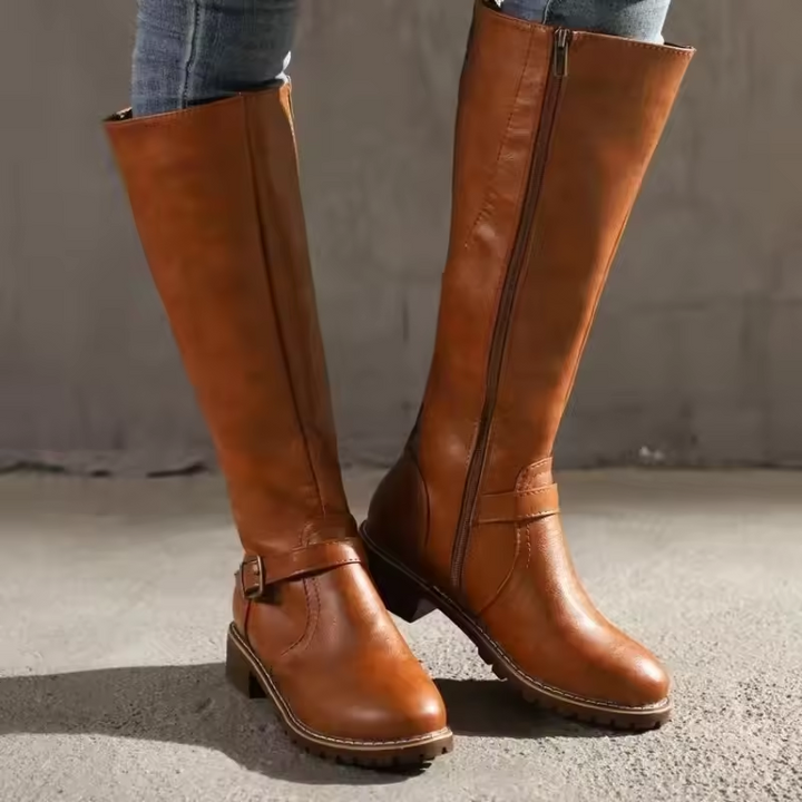 Tan knee-high leather boots with side zipper and buckle accent
