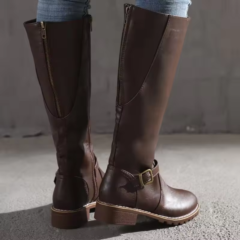 Rear view of brown knee-high boots showing zipper and leather texture