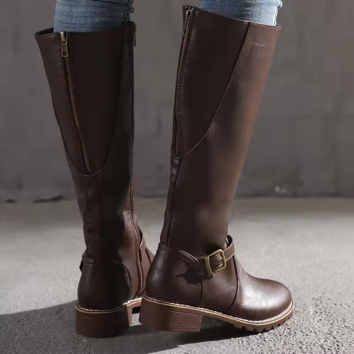 Rear view of brown knee-high boots showing zipper and leather texture