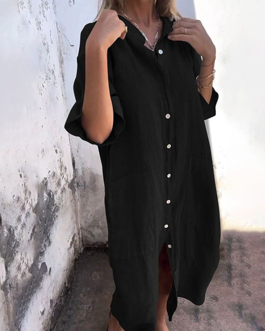 Black oversized button-down shirt dress with side pockets and midi length