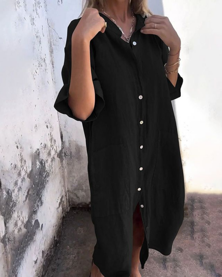 Black oversized button-down shirt dress with side pockets and midi length
