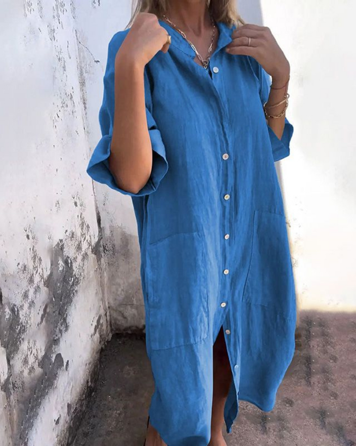 Blue linen shirt dress featuring front buttons and roomy patch pockets