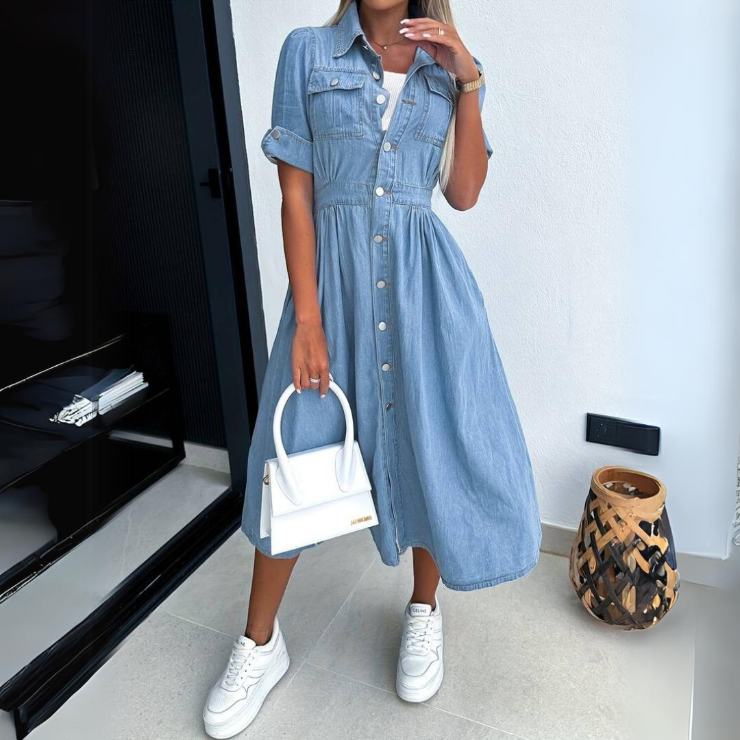 Woman wearing light blue denim button-up midi dress with short sleeves and collar