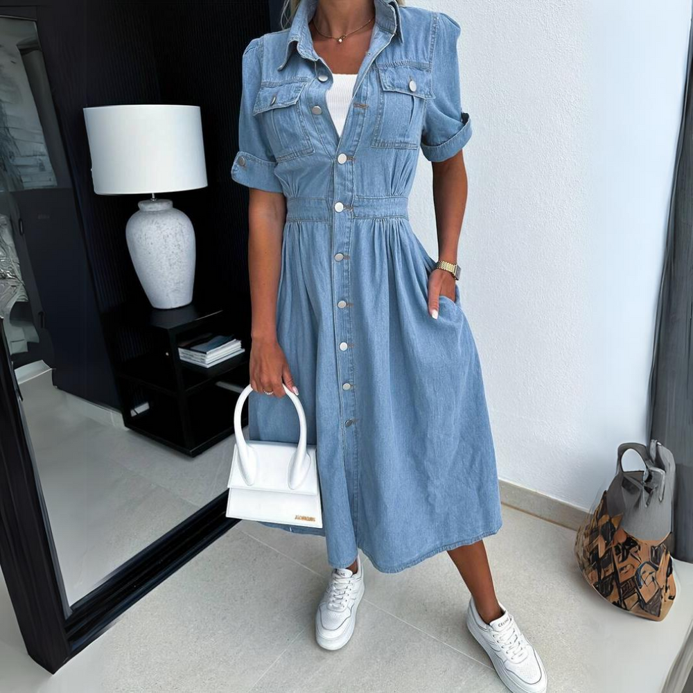 Denim button-up midi dress paired with white sneakers and a top-handle bag