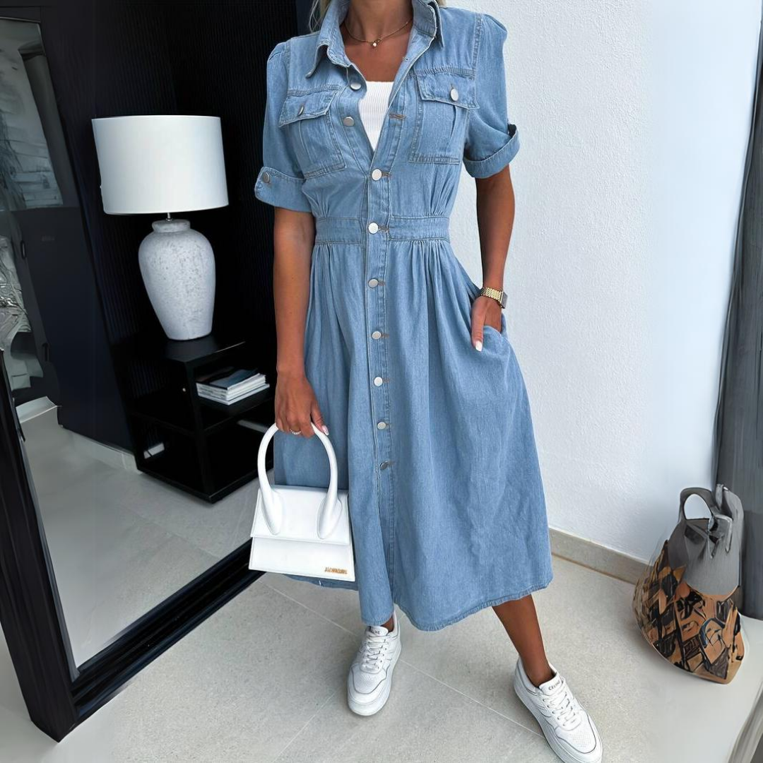 Denim button-up midi dress paired with white sneakers and a top-handle bag