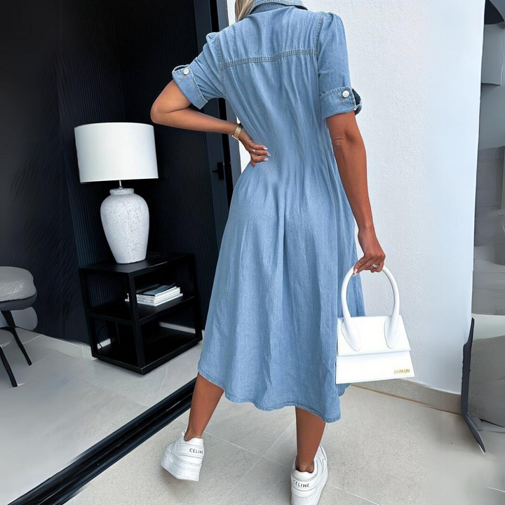 Back view of denim midi dress highlighting flared skirt and fit