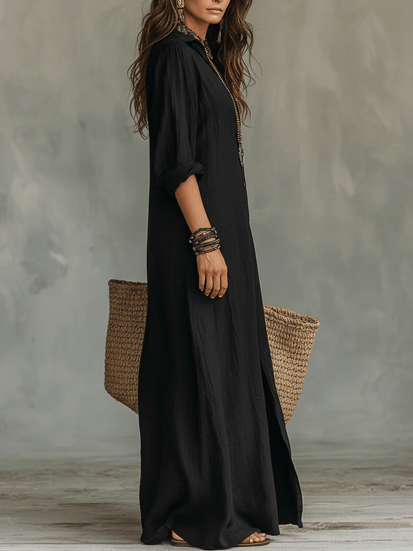 Side view of black long-sleeve maxi shirt dress with rolled cuffs and flowing hem