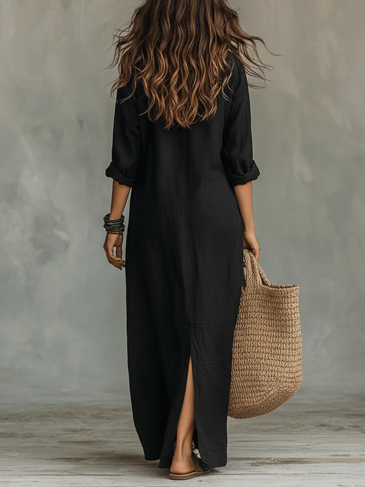Back view of black cotton maxi shirt dress showing relaxed fit and side slit