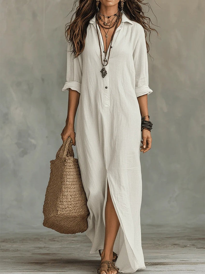 White long-sleeve button-front maxi shirt dress styled with a straw tote bag