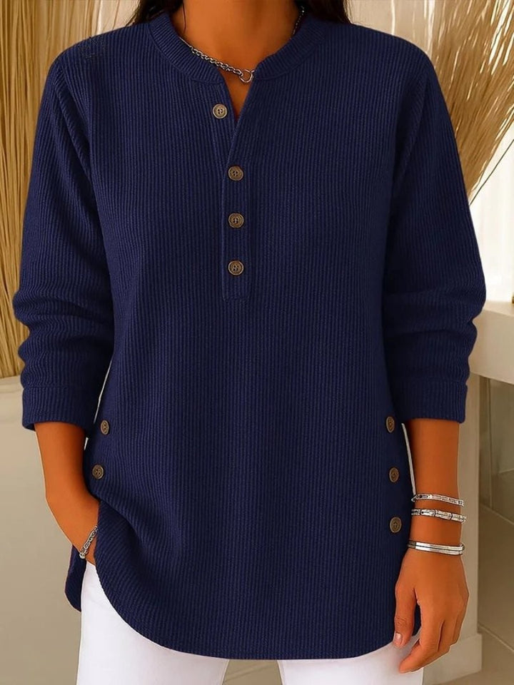 navy blue ribbed sweater with button detail and curved hem