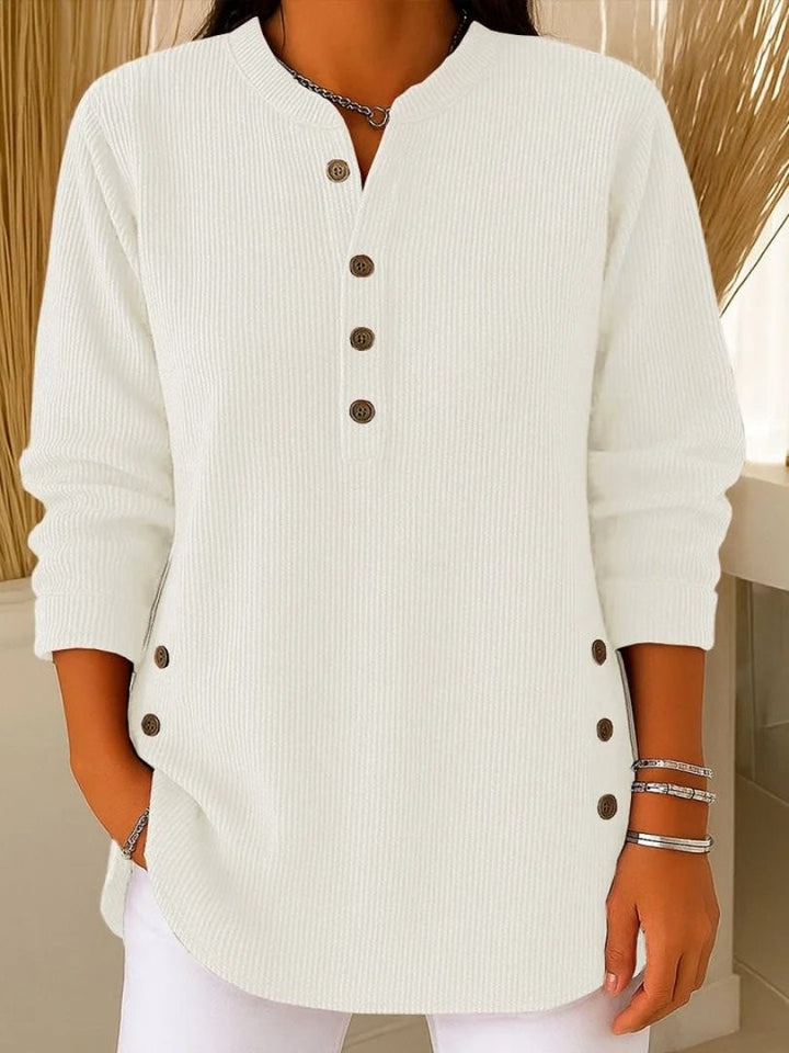 white ribbed knit long sleeve top featuring button placket neckline