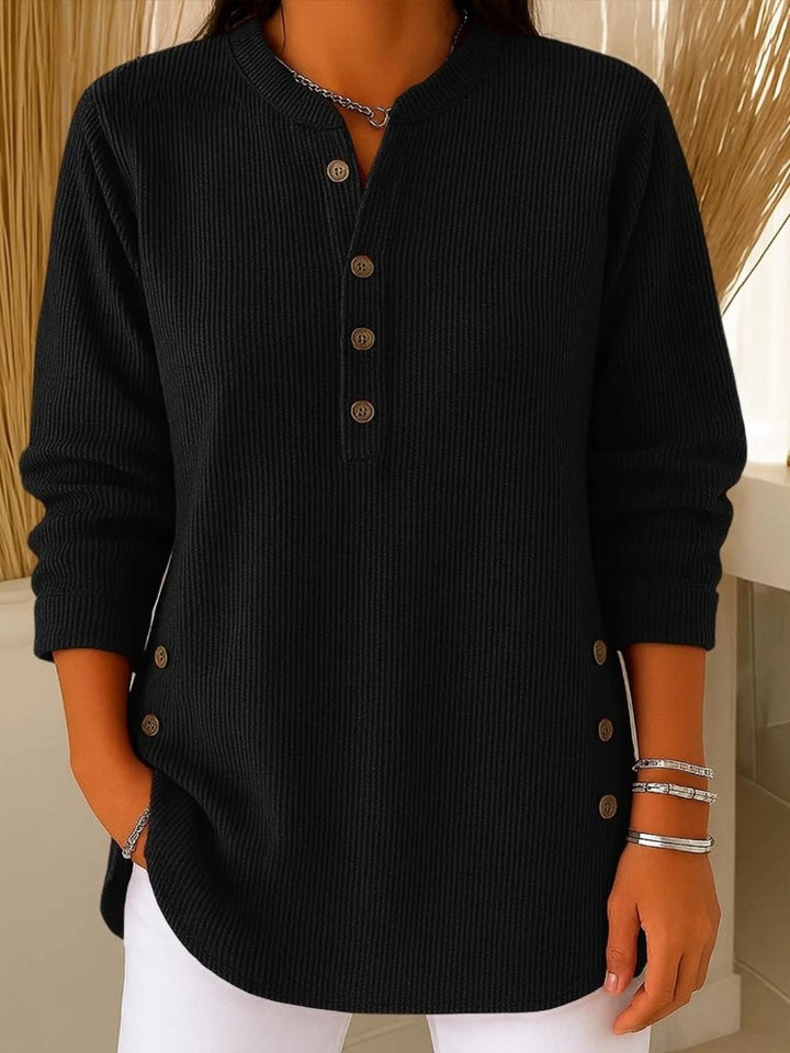 black ribbed knit henley sweater with button accents and side slits