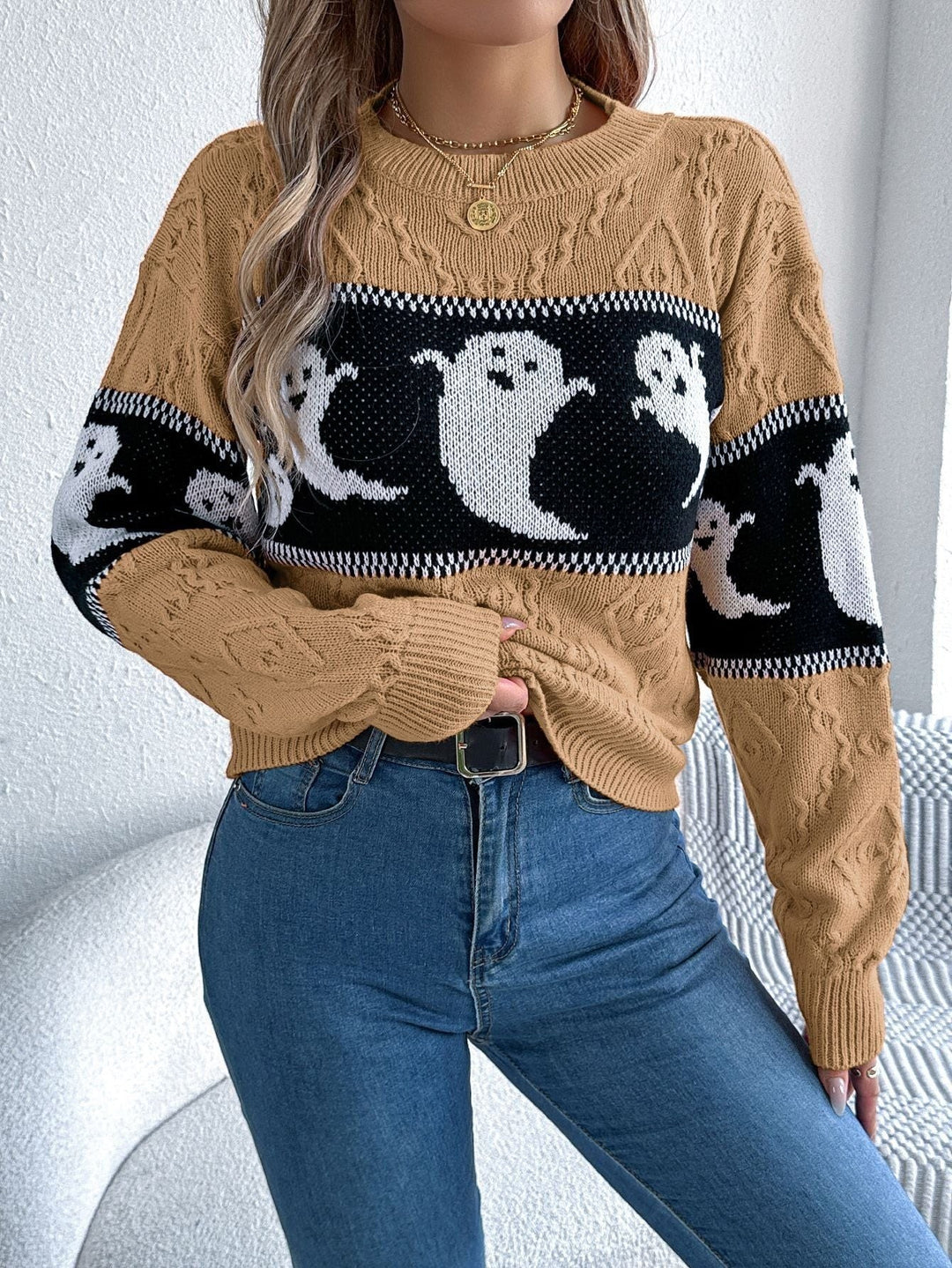 Camel cable-knit sweater featuring ghost print stripe, styled with denim jeans