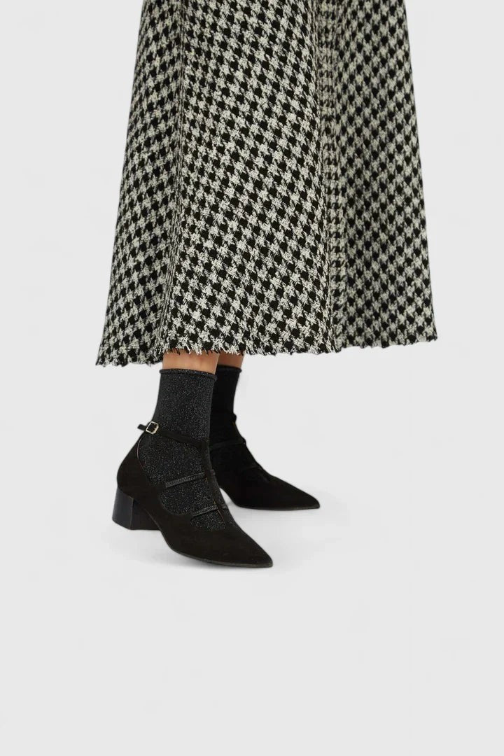 black glitter ankle booties paired with houndstooth midi skirt