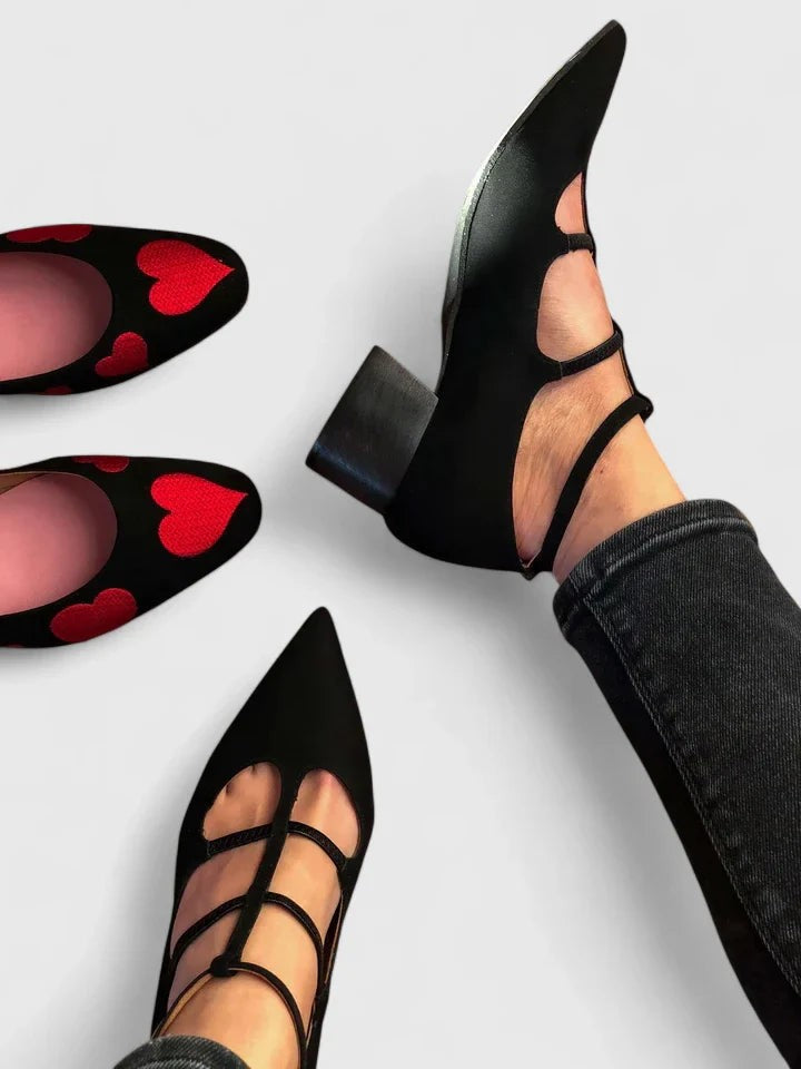 black pointed-toe heels with cutout straps and low block heel