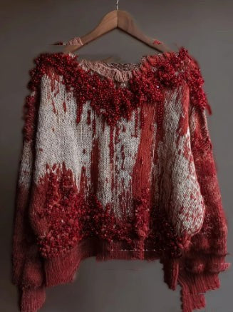 cream and red distressed sweater with beaded drip and fringe accents