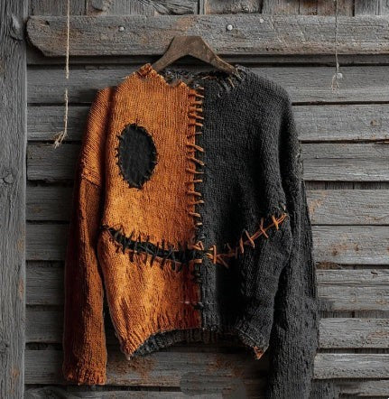 orange and black distressed sweater with stitched patchwork jack-o-lantern face