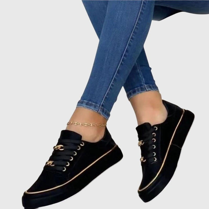 Black velvet sneakers with gold chain accent and platform outsole