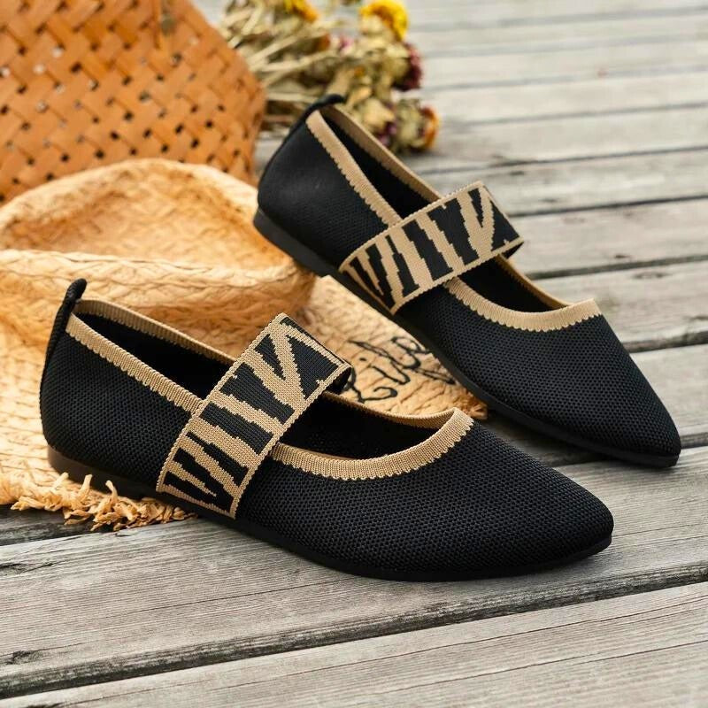 Black knit pointed-toe flats with tan striped Mary Jane strap detail