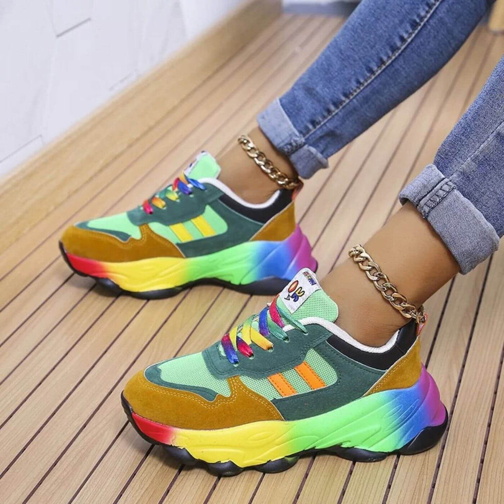 Green and mustard chunky sneakers with tie-dye rainbow platform sole, worn with cuffed denim